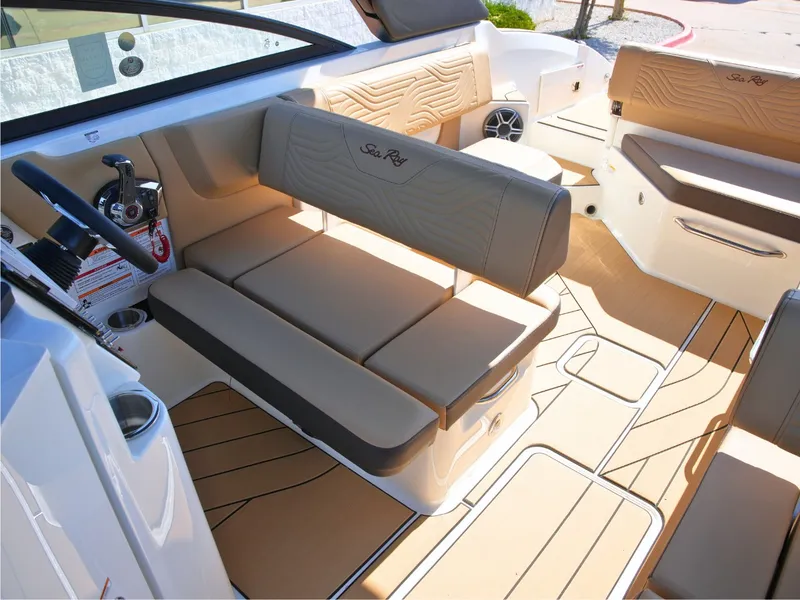Slide: The Image of The image shows the cockpit of a Sea Ray SDX 270 Surf boat with sleek seating and modern design. - 25