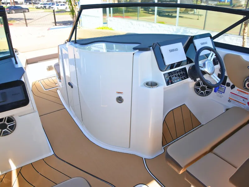 Slide: The Image of The image shows the cockpit of a 2027 Sea Ray SDX 270 Surf with modern instruments. - 37