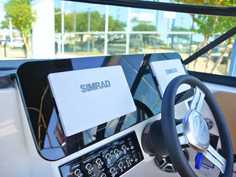 Slide: The Image of The image shows the dashboard of a Sea Ray SDX 270 Surf with Simrad screens. - 28