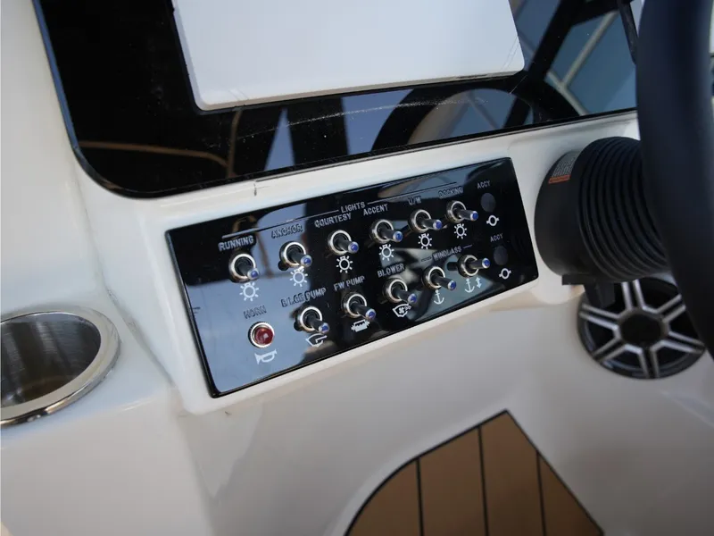 Slide: The Image of The image shows the dashboard of a Sea Ray SDX 270 Surf with various switches and indicators. - 29