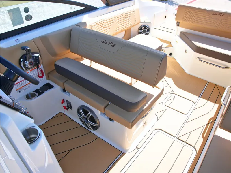 Slide: The Image of The image shows the interior of a Sea Ray SDX 270 Surf boat with beige seating and modern details. - 24