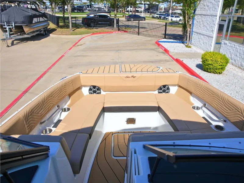 Slide: The Image of The image shows the spacious cockpit of a Sea Ray SDX 270 Surf with beige upholstery. - 43