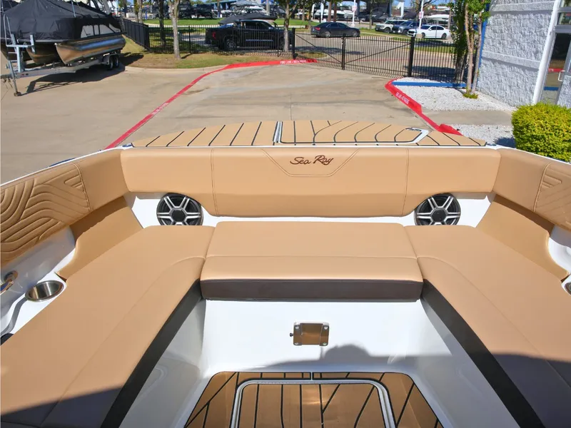 Slide: The Image of The image shows the cockpit of a 2027 Sea Ray SDX 270 Surf with beige upholstery. - 45
