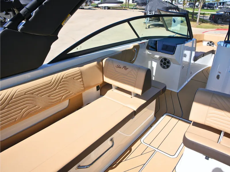 Slide: The Image of The image shows the interior of a Sea Ray SDX 270 Surf boat with beige seating and modern design. - 17