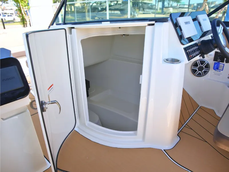 Slide: The Image of The image shows the interior of a 2027 Sea Ray SDX 270 Surf with an open storage compartment. - 38