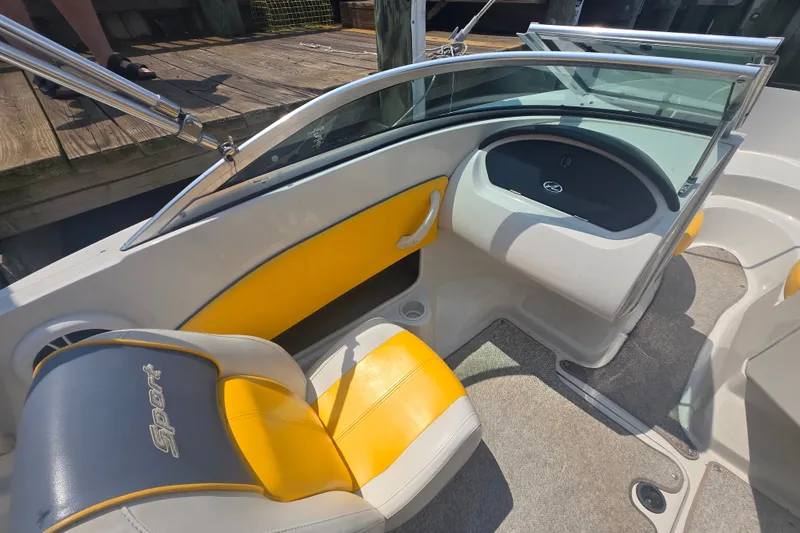 Slide: The Image of Interior of a 2007 Sea Ray 185 Sport boat with yellow and gray seating. - 6