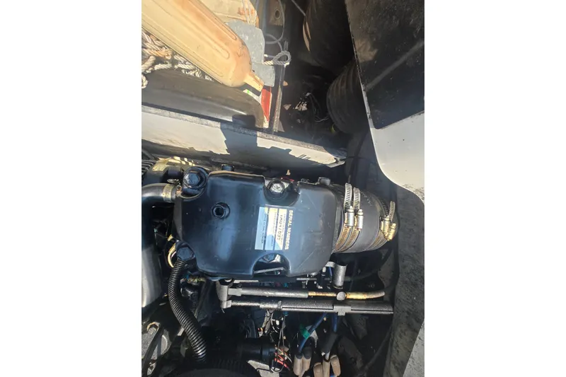 Slide: The Image of Engine compartment of a 2007 Sea Ray 185 Sport boat, showcasing mechanical components. - 8