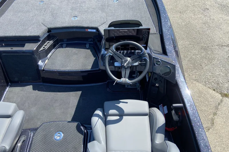 Slide: The Image of Cockpit view of 2026 iKon VLX 21 boat with steering wheel and seating. - 2