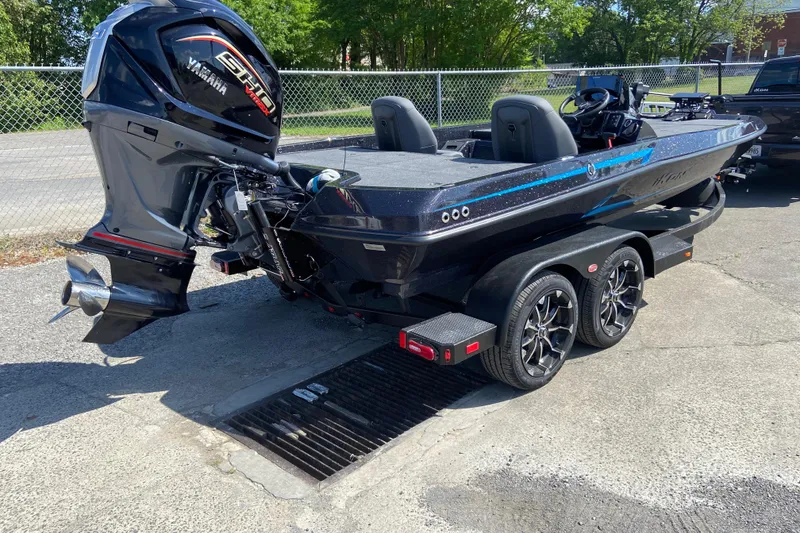 Slide: The Image of 2026 iKon VLX 21 boat with Yamaha engine on a trailer, parked outdoors. - 1