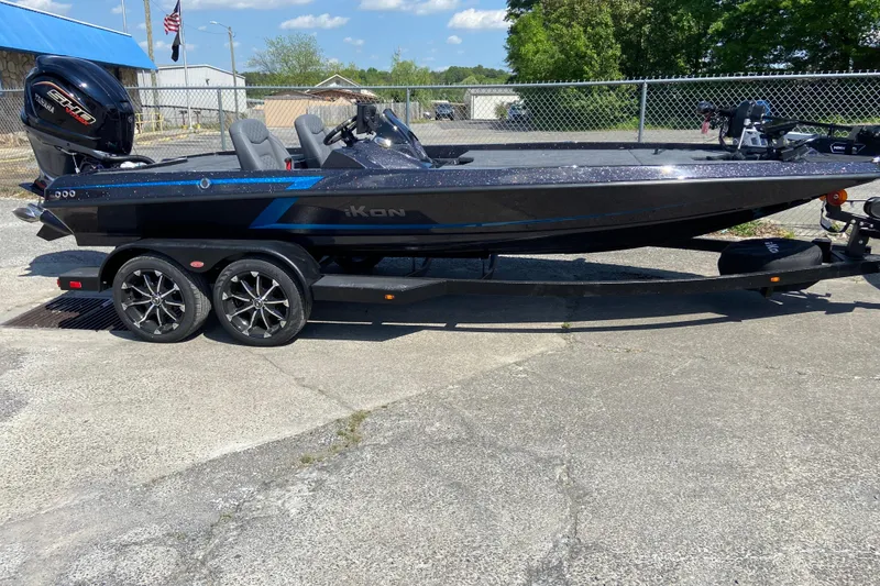 Slide: The Image of 2026 iKon VLX 21 boat on trailer, sleek design, dual axles, outdoor setting. - 0