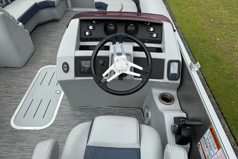 Slide: The Image of 2022 Bennington LX 22 Swingback boat dashboard with steering wheel and control panel. - 24