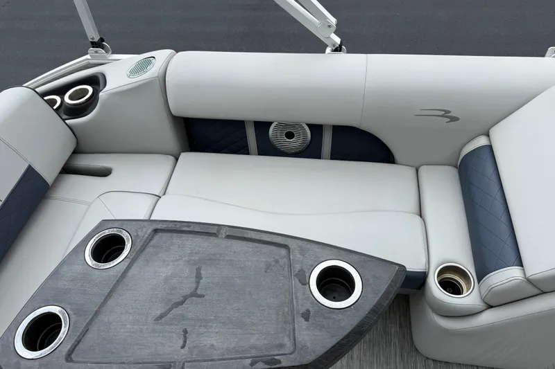 Slide: The Image of Luxurious seating area on 2022 Bennington LX 22 Swingback boat with cup holders and table. - 28