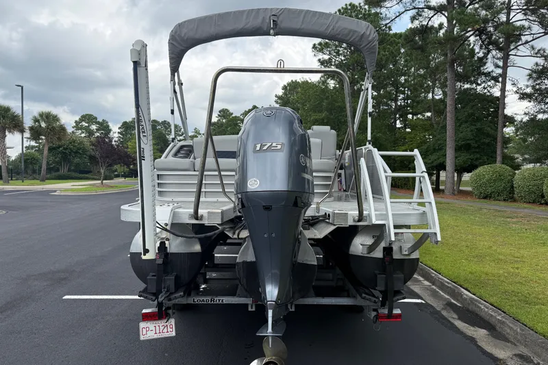 Slide: The Image of 2022 Bennington LX 22 Swingback pontoon boat with Yamaha 175 engine, parked outdoors. - 6