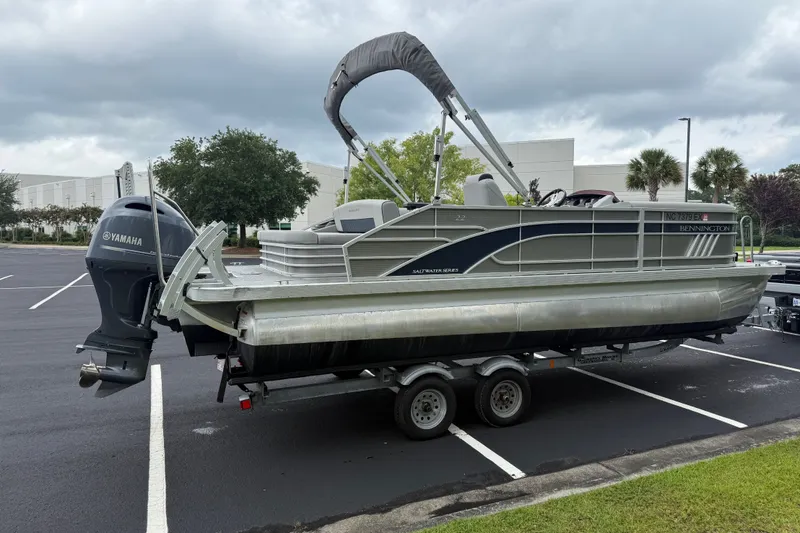 Slide: The Image of 2022 Bennington LX 22 Swingback pontoon boat on trailer with Yamaha outboard motor. - 8