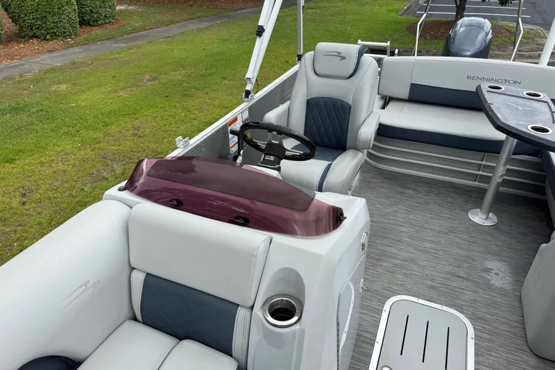 Slide: The Image of 2022 Bennington LX 22 Swingback interior with plush seating and modern helm. - 16
