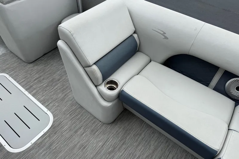Slide: The Image of 2022 Bennington LX 22 Swingback boat interior with cushioned seating and cup holder. - 18