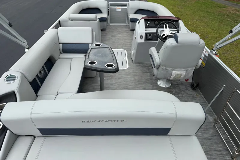 Slide: The Image of 2022 Bennington LX 22 Swingback pontoon boat interior with plush seating and modern helm. - 23