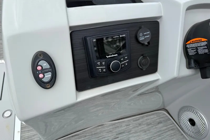 Slide: The Image of Control panel of 2022 Bennington LX 22 Swingback with audio system and warning label. - 25