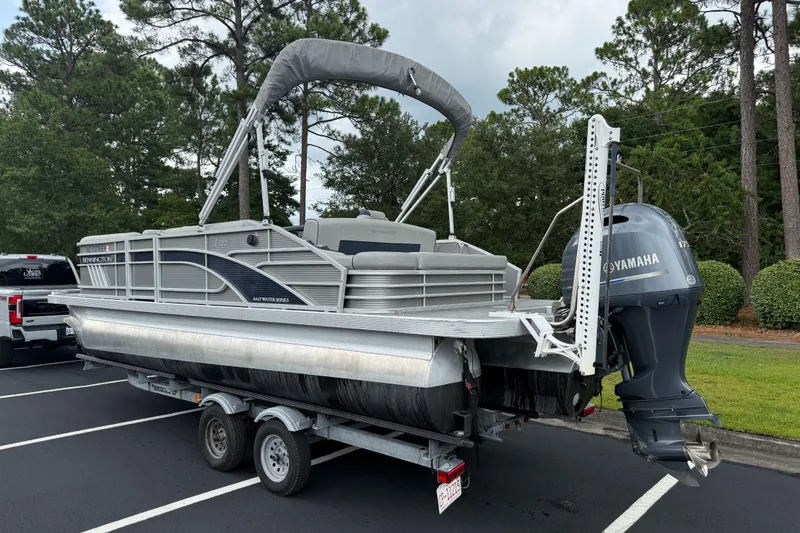 Slide: The Image of 2022 Bennington LX 22 Swingback pontoon boat on trailer with Yamaha outboard motor. - 4