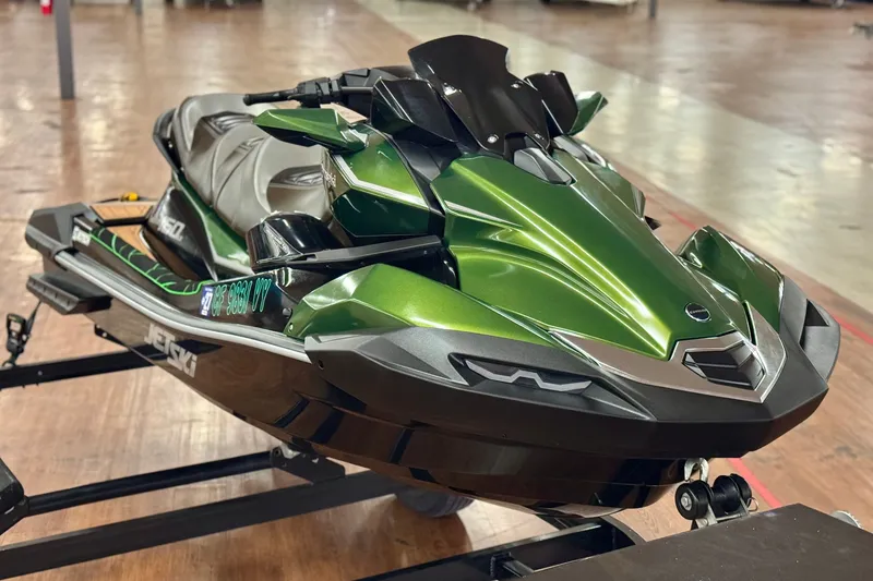 Slide: The Image of 2025 Kawasaki JET SKI ULTRA 160 LX in vibrant green on display indoors. - 3