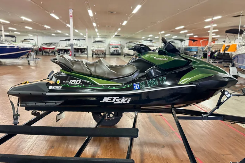 Slide: The Image of 2025 Kawasaki JET SKI ULTRA 160 LX in showroom, side view, green and black design. - 4