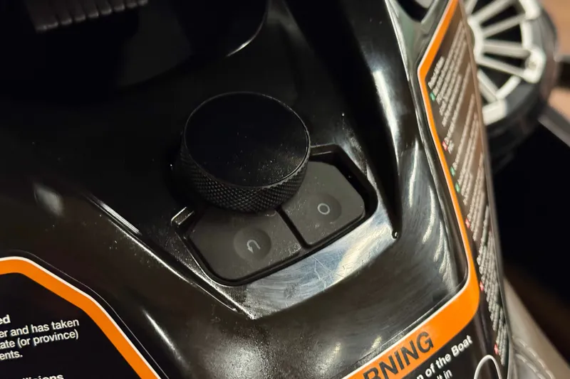 Slide: The Image of Close-up of 2025 Kawasaki JET SKI ULTRA 160 LX control panel with warning label. - 12