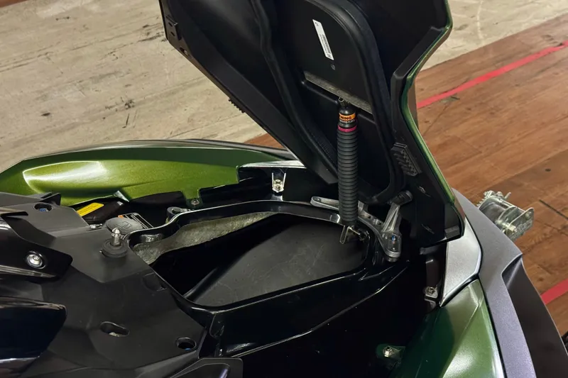 Slide: The Image of Open storage compartment of 2025 Kawasaki JET SKI ULTRA 160 LX on wooden floor. - 15