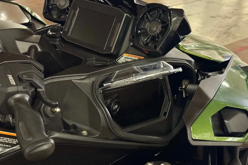 Slide: The Image of 2025 Kawasaki JET SKI ULTRA 160 LX dashboard with USB port and storage compartment. - 14