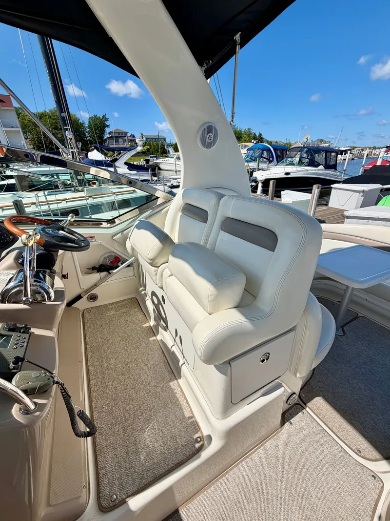 Slide: The Image of The image shows the cockpit of a 2003 Sea Ray Sundancer 320 with white seating. - 5
