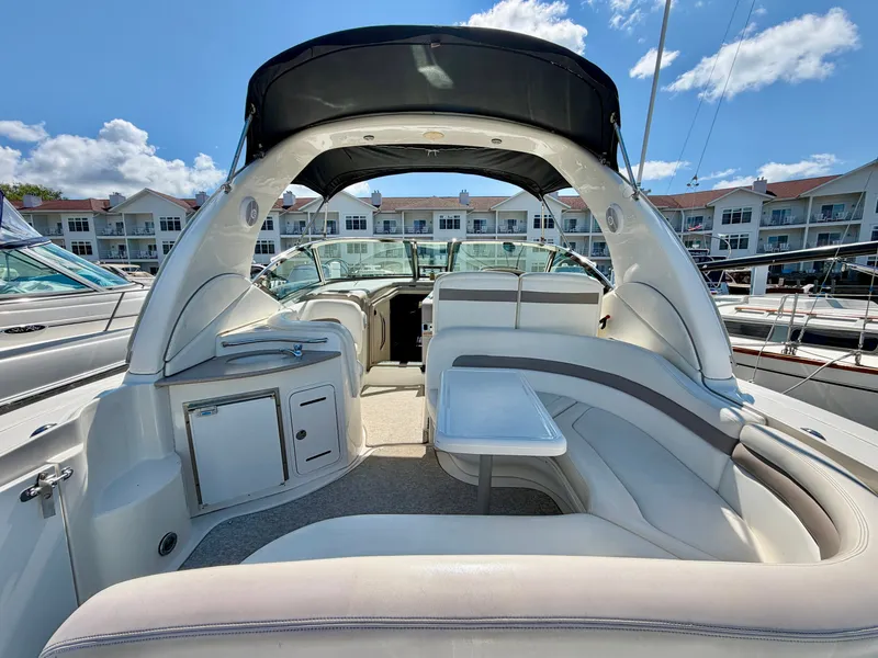 Slide: The Image of The image shows the cockpit of a 2003 Sea Ray Sundancer 320 with curved seating and a table. - 6
