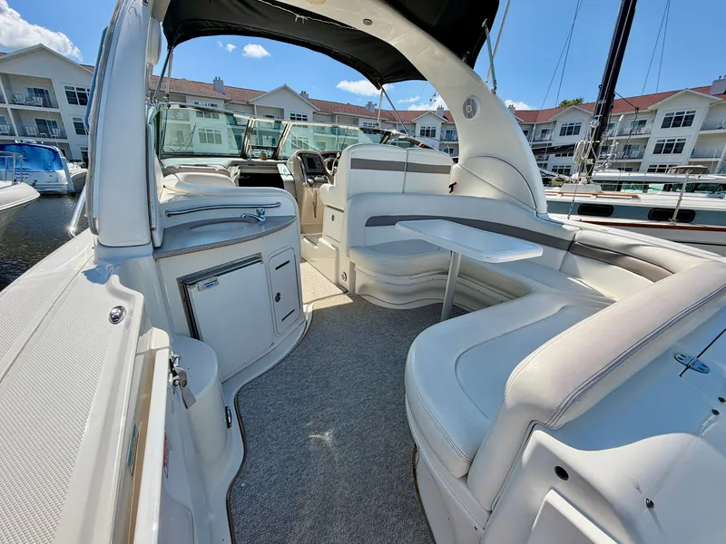 Slide: The Image of The image shows the cockpit of a 2003 Sea Ray Sundancer 320 with white seating and a table. - 7
