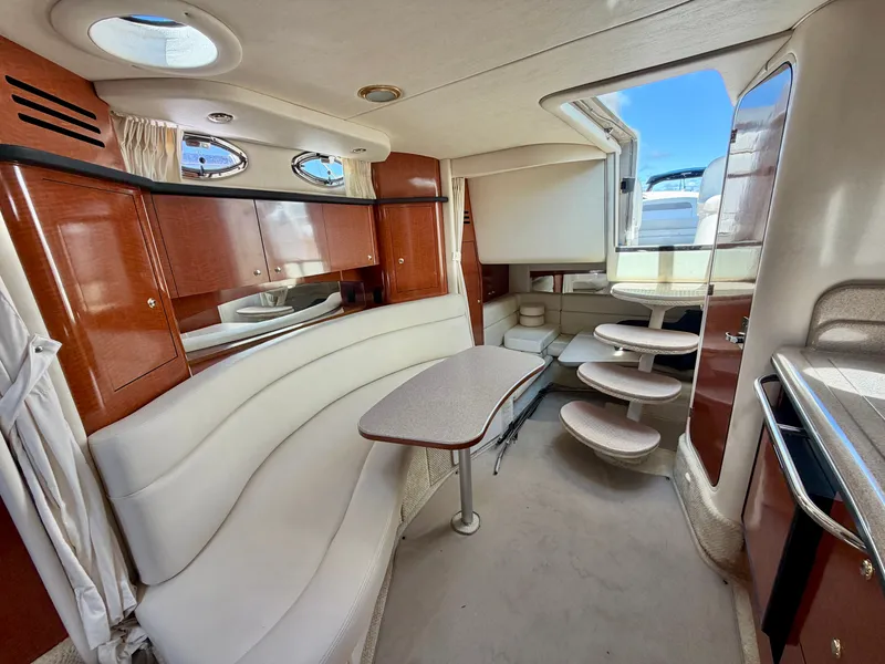 Slide: The Image of Interior of a 2003 Sea Ray Sundancer 320 with elegant seating area and stairs to the cabin. - 10