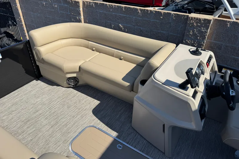 Slide: The Image of 2027 Godfrey EX 2286 SBX boat interior with beige seating and modern dashboard. - 5