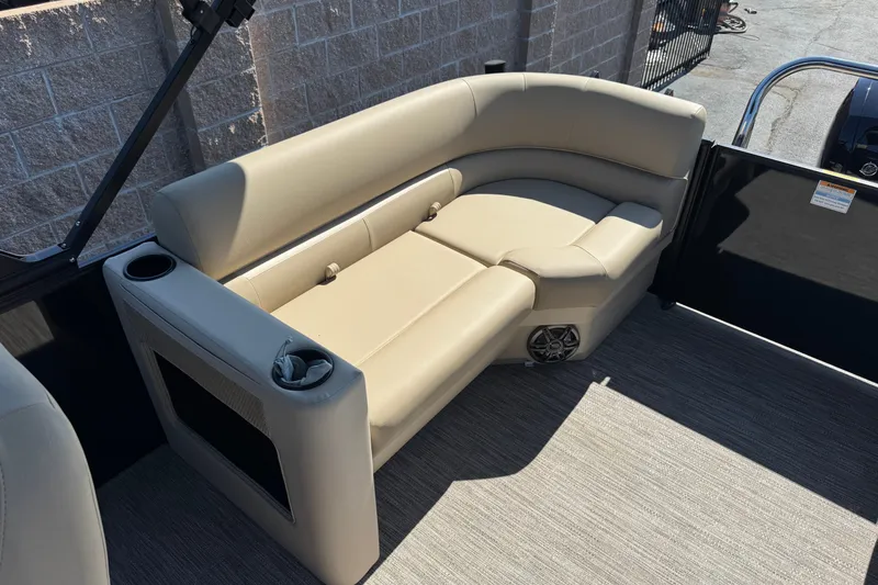 Slide: The Image of Luxurious seating on 2027 Godfrey EX 2286 SBX pontoon boat, featuring beige upholstery and cup holders. - 10