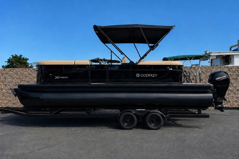 The Image of 2027 Godfrey Xperience 23' Split Bench pontoon boat with Mercury engine on trailer. - 0