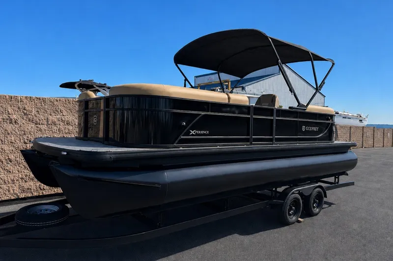 Slide: The Image of 2027 Godfrey Xperience 23' Split Bench pontoon boat on trailer, black with tan seating. - 1