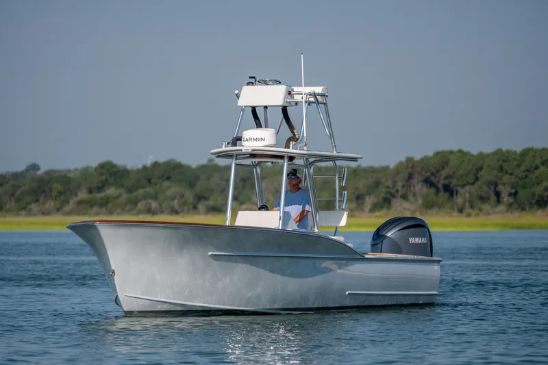 Slide: The Image of 2023 Harrison Boatworks 28 on water, featuring Garmin equipment and Yamaha engine. - 37