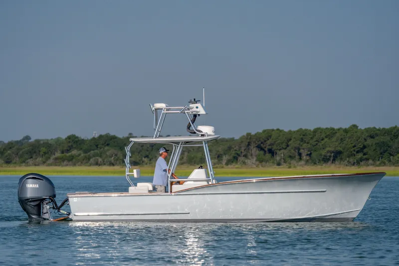 Slide: The Image of 2023 Harrison Boatworks 28 cruising on calm water with Yamaha outboard motor. - 15