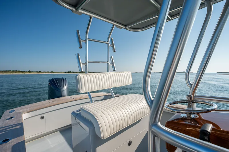 Slide: The Image of 2023 Harrison Boatworks 28 on calm water, featuring sleek seating and polished metalwork. - 9