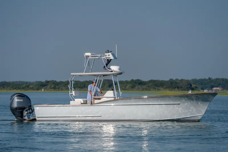 Slide: The Image of 2023 Harrison Boatworks 28 on calm water, featuring Yamaha outboard motor. - 17