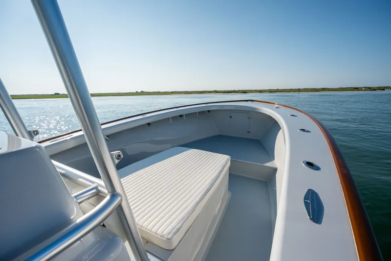 Slide: The Image of 2023 Harrison Boatworks 28 on calm water, showcasing sleek design and spacious seating. - 10