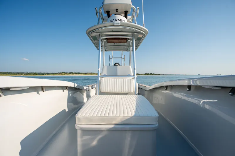 Slide: The Image of 2023 Harrison Boatworks 28 on calm water, featuring sleek design and Garmin equipment. - 11