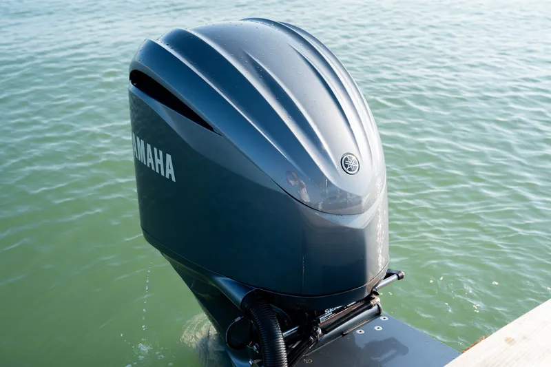 Slide: The Image of Yamaha outboard motor on 2023 Harrison Boatworks 28, floating in calm water. - 44