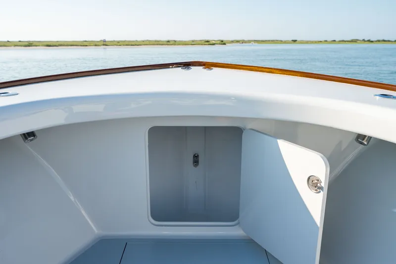 Slide: The Image of 2023 Harrison Boatworks 28, open storage compartment, scenic water view. - 46