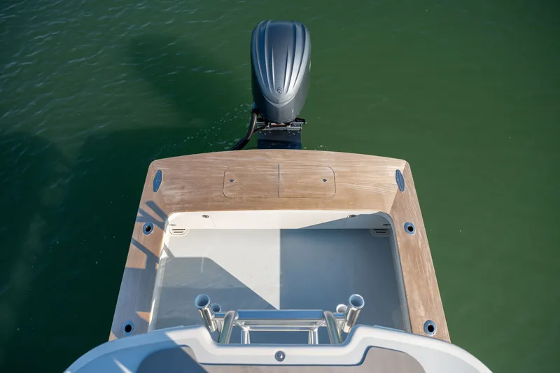 Slide: The Image of 2023 Harrison Boatworks 28 with outboard motor on calm water. - 29