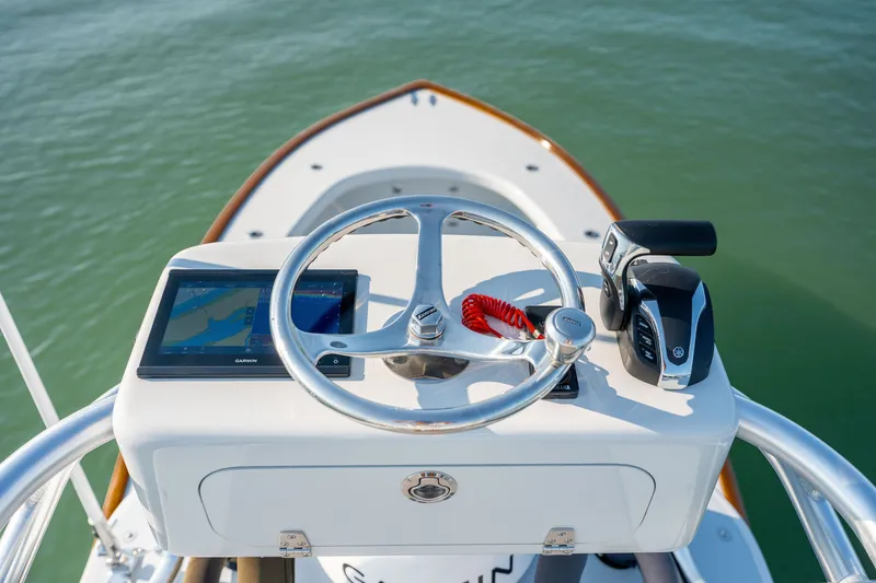 Slide: The Image of Steering console of 2023 Harrison Boatworks 28 with navigation display and controls. - 25