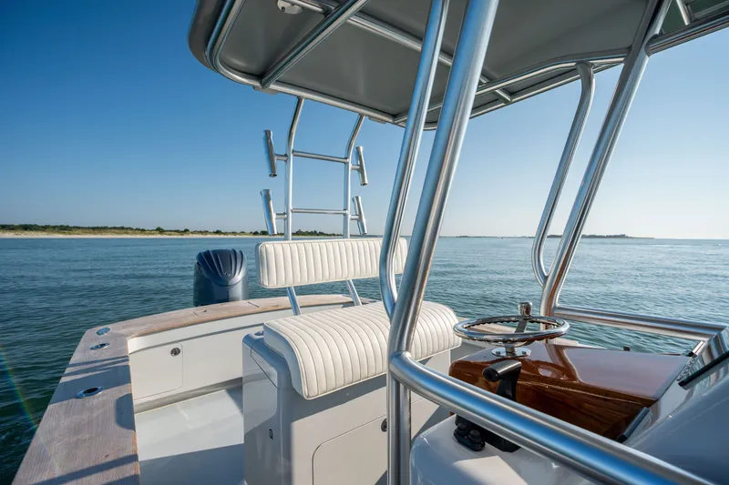 Slide: The Image of 2023 Harrison Boatworks 28 on calm water, featuring sleek design and modern helm. - 22