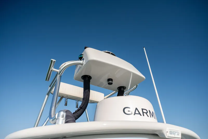 Slide: The Image of 2023 Harrison Boatworks 28 with Garmin equipment against clear blue sky. - 30