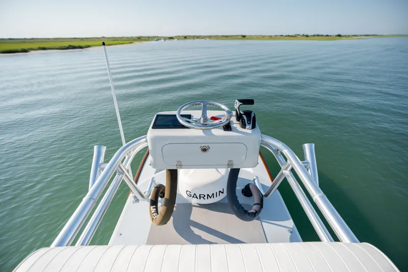 Slide: The Image of 2023 Harrison Boatworks 28 helm with Garmin navigation on calm water. - 24