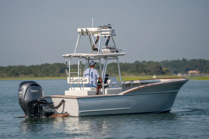 Slide: The Image of 2023 Harrison Boatworks 28 on water, featuring Yamaha 300 V6 engine, scenic background. - 13